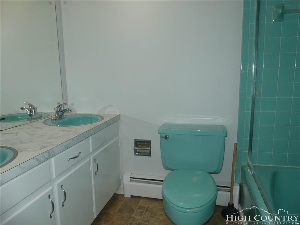 567 Deck Hill Road Boone, NC 28607 - Photo 13 of 25 a bathroom with a toilet and a sink