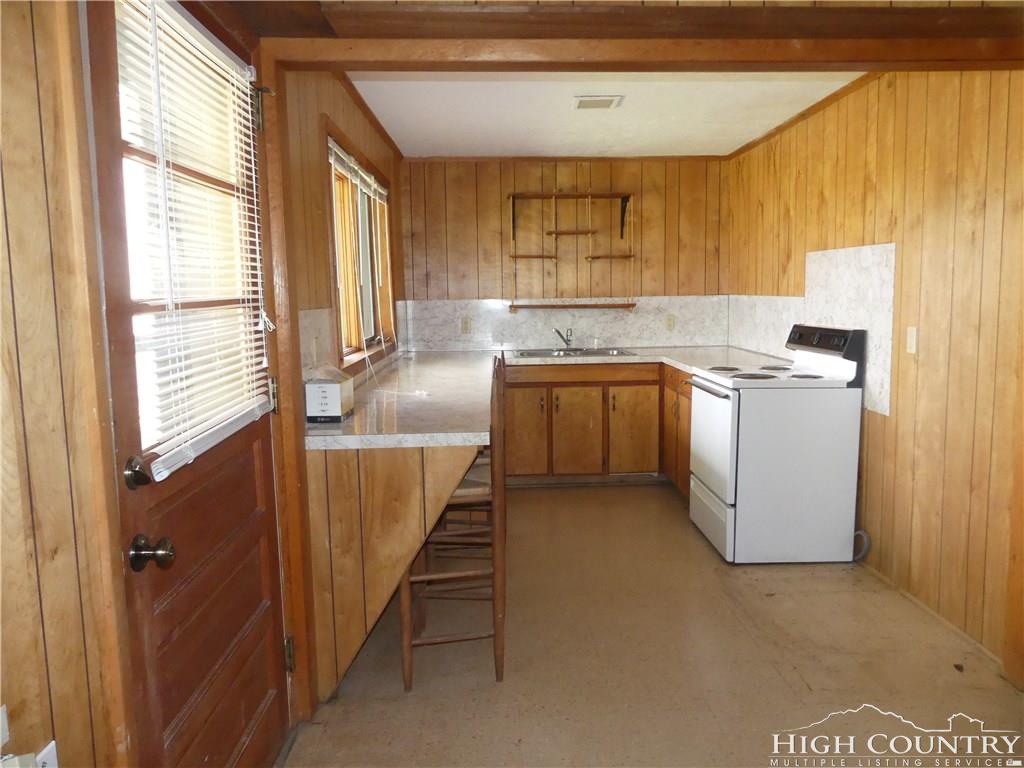 567 Deck Hill Road Boone, NC 28607 - Photo 20 of 25 a kitchen with a sink a stove and cabinets