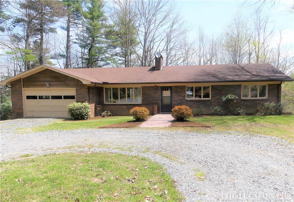 567 Deck Hill Road Boone, NC 28607 - Photo 24 of 25 a front view of a house with a garden and tree