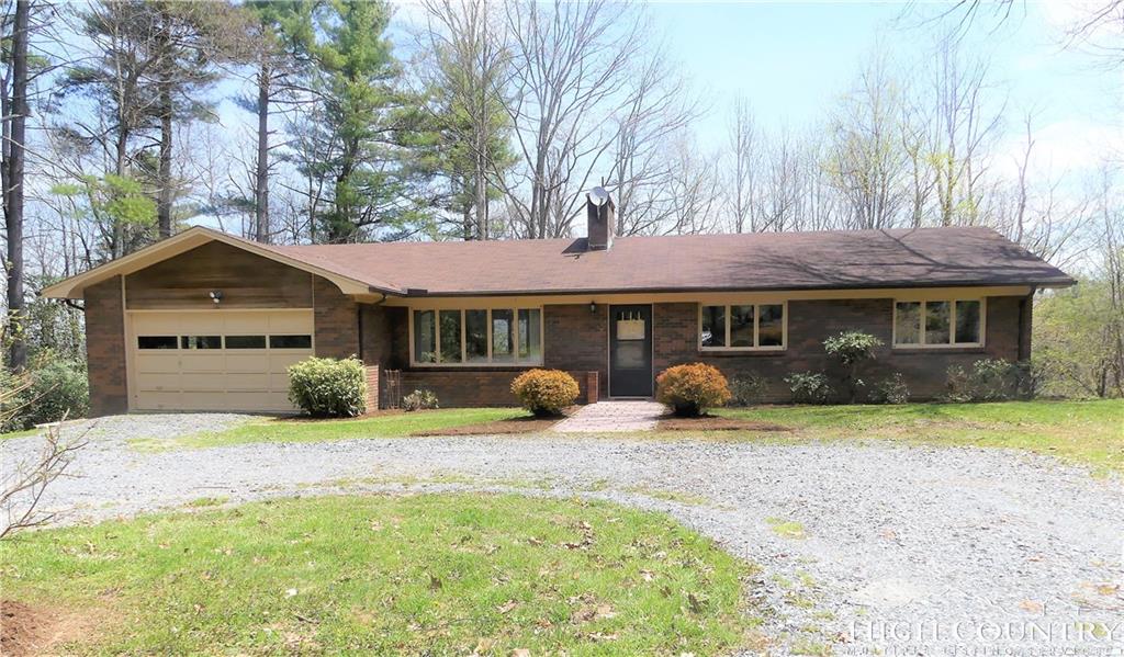 567 Deck Hill Road Boone, NC 28607 - Photo 25 of 25 a front view of a house with yard and trees in the background