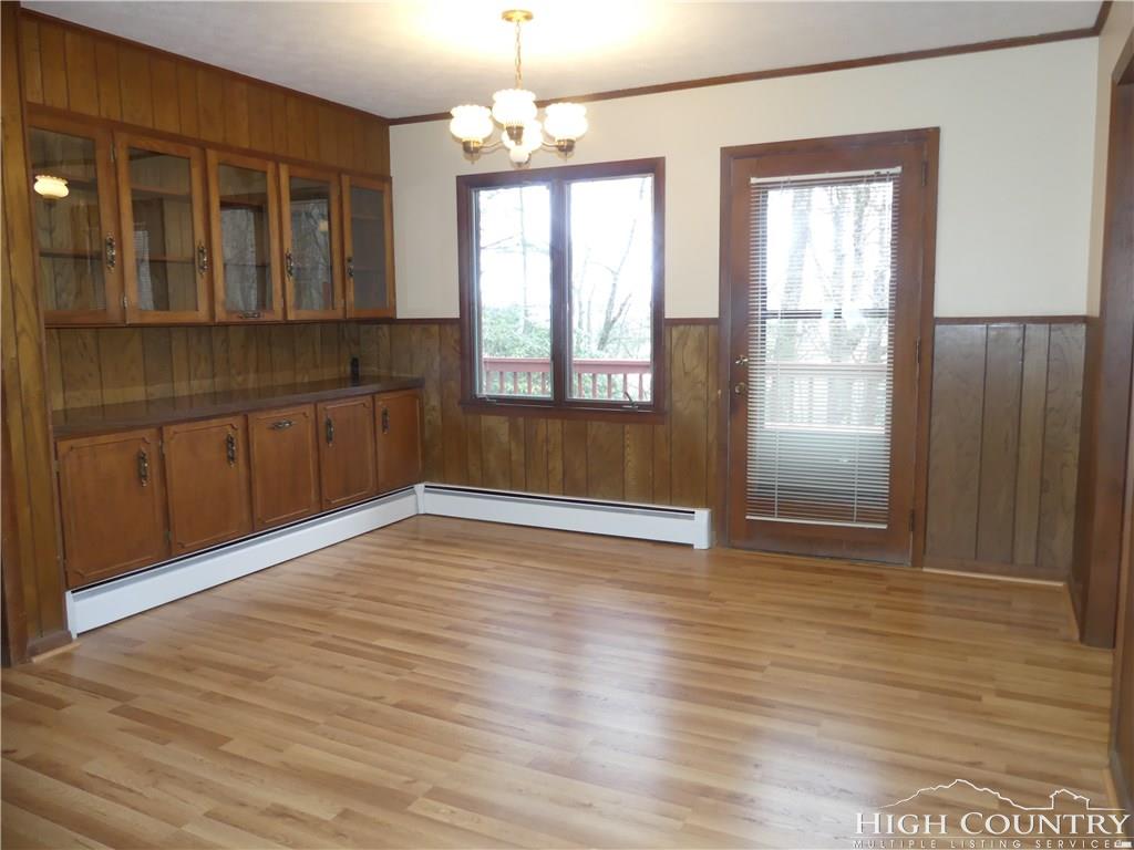 567 Deck Hill Road Boone, NC 28607 - Photo 4 of 25 an empty room with wooden floor and windows