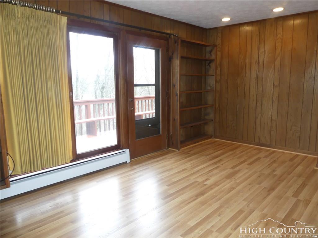 567 Deck Hill Road Boone, NC 28607 - Photo 7 of 25 a view of an empty room with wooden floor and a window
