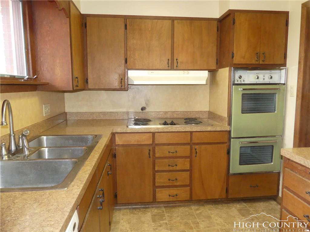 567 Deck Hill Road Boone, NC 28607 - Photo 8 of 25 a kitchen with stainless steel appliances granite countertop a sink and a stove