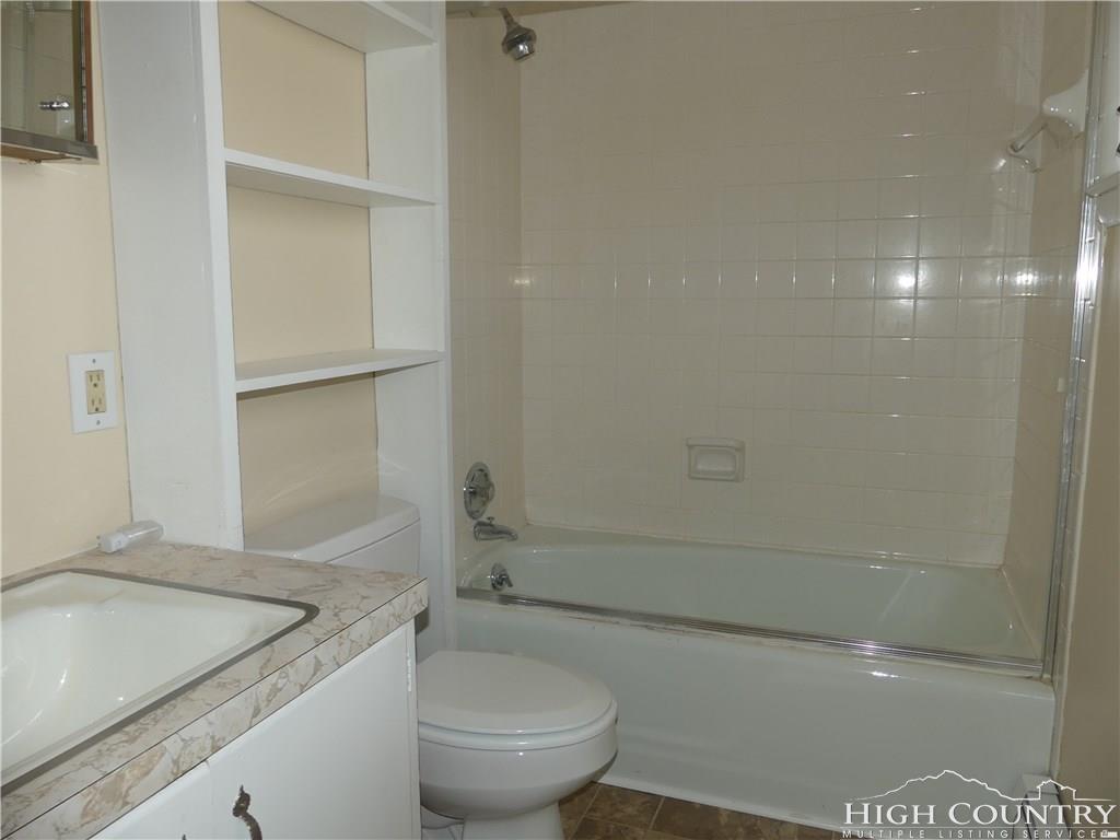 567 Deck Hill Road Boone, NC 28607 - Photo 10 of 25 a bathroom with a granite countertop sink toilet and shower
