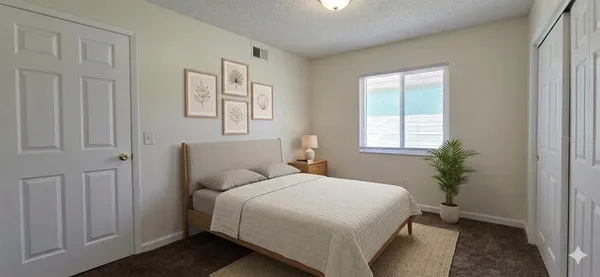 a bedroom with a bed and a window