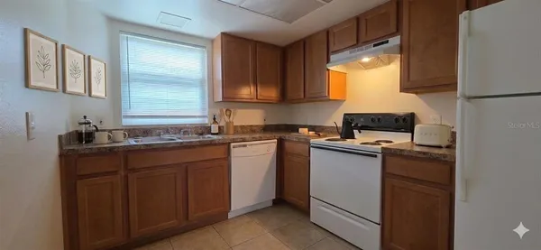 a kitchen with a sink cabinets and window