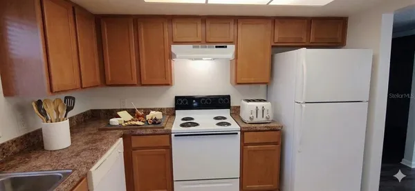 a kitchen with a refrigerator and a stove