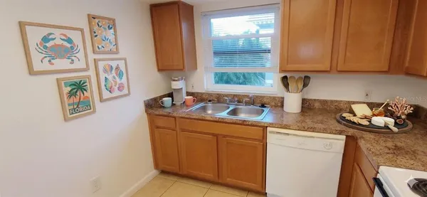 a kitchen with stainless steel appliances granite countertop a sink and a wooden cabinets