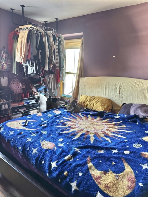 495 Warren Street Boston, MA 02121 - Photo 21 of 25 a bedroom with a bed and a mirror