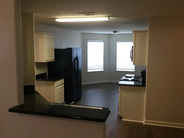 a living room with hard wood floor and a window