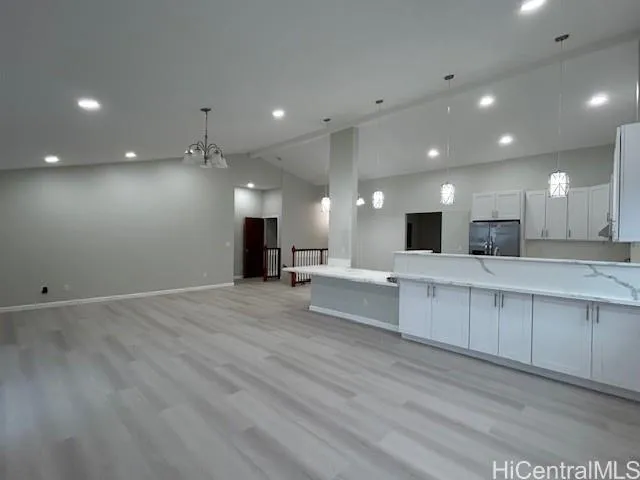 a large kitchen with stainless steel appliances a large counter top