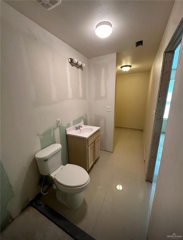 1950 County Road 221 Florence, TX 76527 - Photo 6 of 13 a bathroom with a toilet a sink and mirror