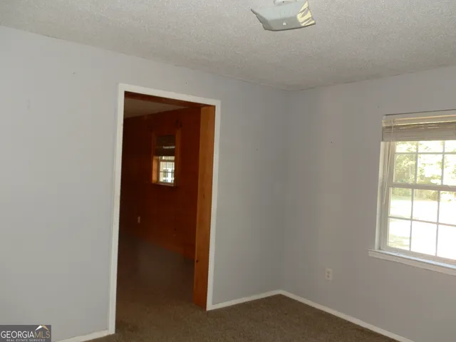 a view of a livingroom with a ceiling fan and window