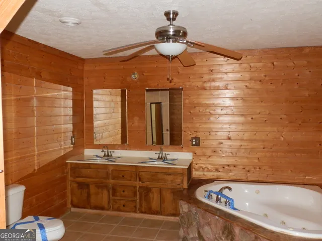 a bathroom with a sink a mirror and a window