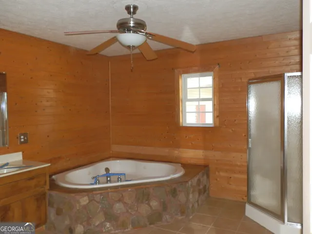 a bathroom with a granite countertop sink mirror vanity and toilet