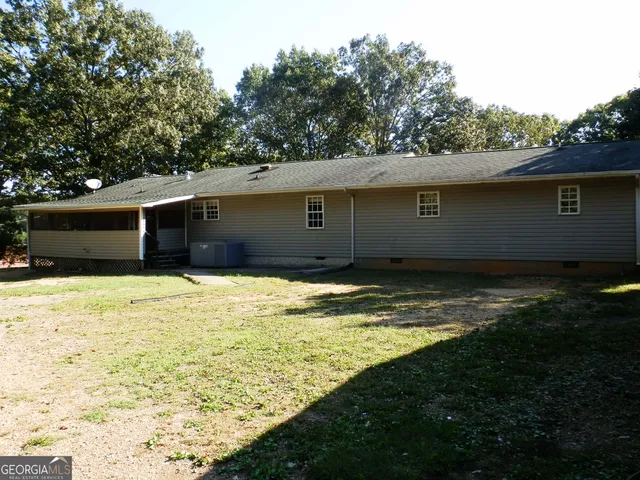 a view of house with backyard
