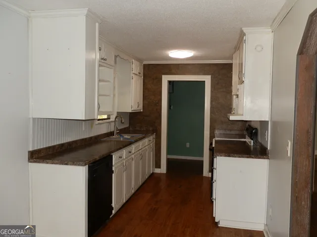 a kitchen with a sink and a refrigerator
