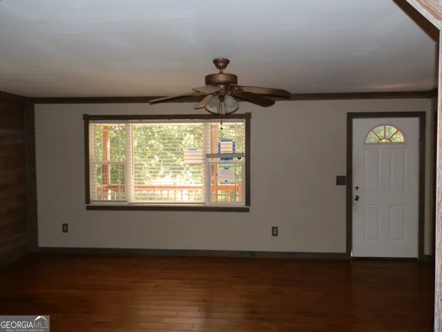 a view of an empty room and a window