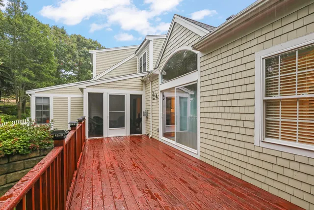 a view of a house with wooden deck