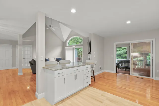 a spacious bathroom with a granite countertop sink mirror and a bathtub