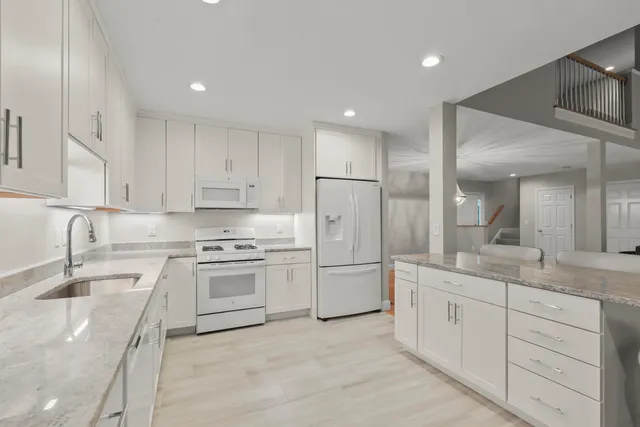 a kitchen with a sink stove and cabinets
