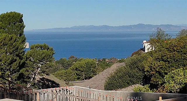 a view of a yard and an ocean view