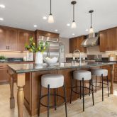 a kitchen with granite countertop a counter space a sink stainless steel appliances and cabinets
