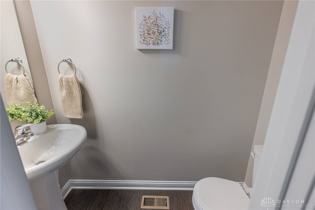 407 Brownstone Row Springboro, OH 45066 - Photo 22 of 54 This clean and inviting powder room offers a pedestal sink and modern toilet.