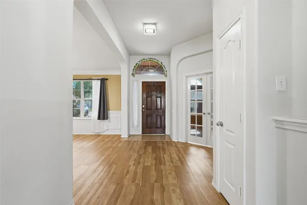 a view of a hallway with wooden floor and a fireplace