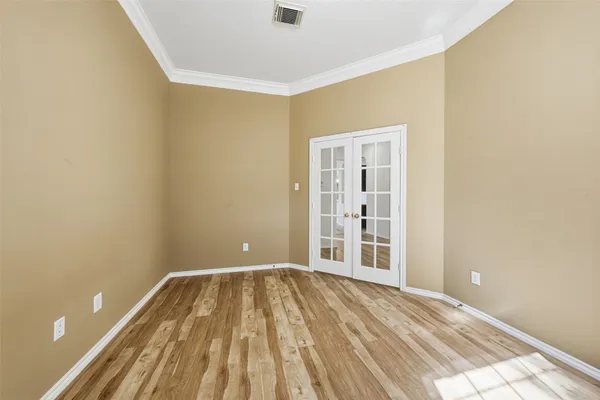 a view of a room with wooden floor and bathroom