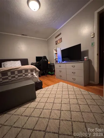 a bed room with a bed and flat screen tv