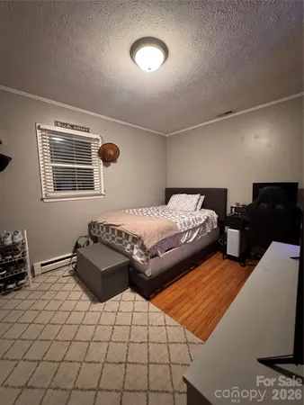 a bedroom with double bed and a window