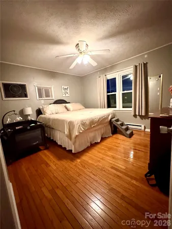 a bedroom with double bed and a large window