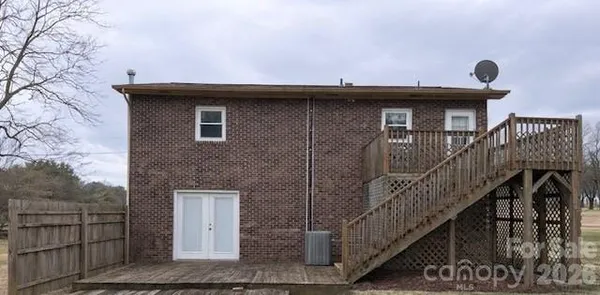 a view of a house with wooden fence