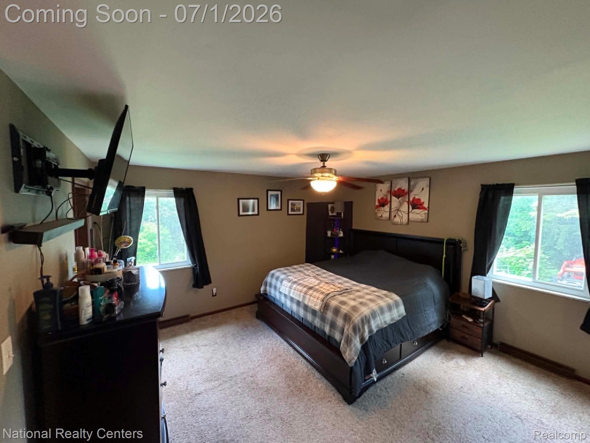 1330 Brauer Road Oxford, MI 48371 - Photo 40 of 54 Carpeted room featuring a ceiling fan with integrated lighting, two windows with dark draperies, and a mounted wall shelf