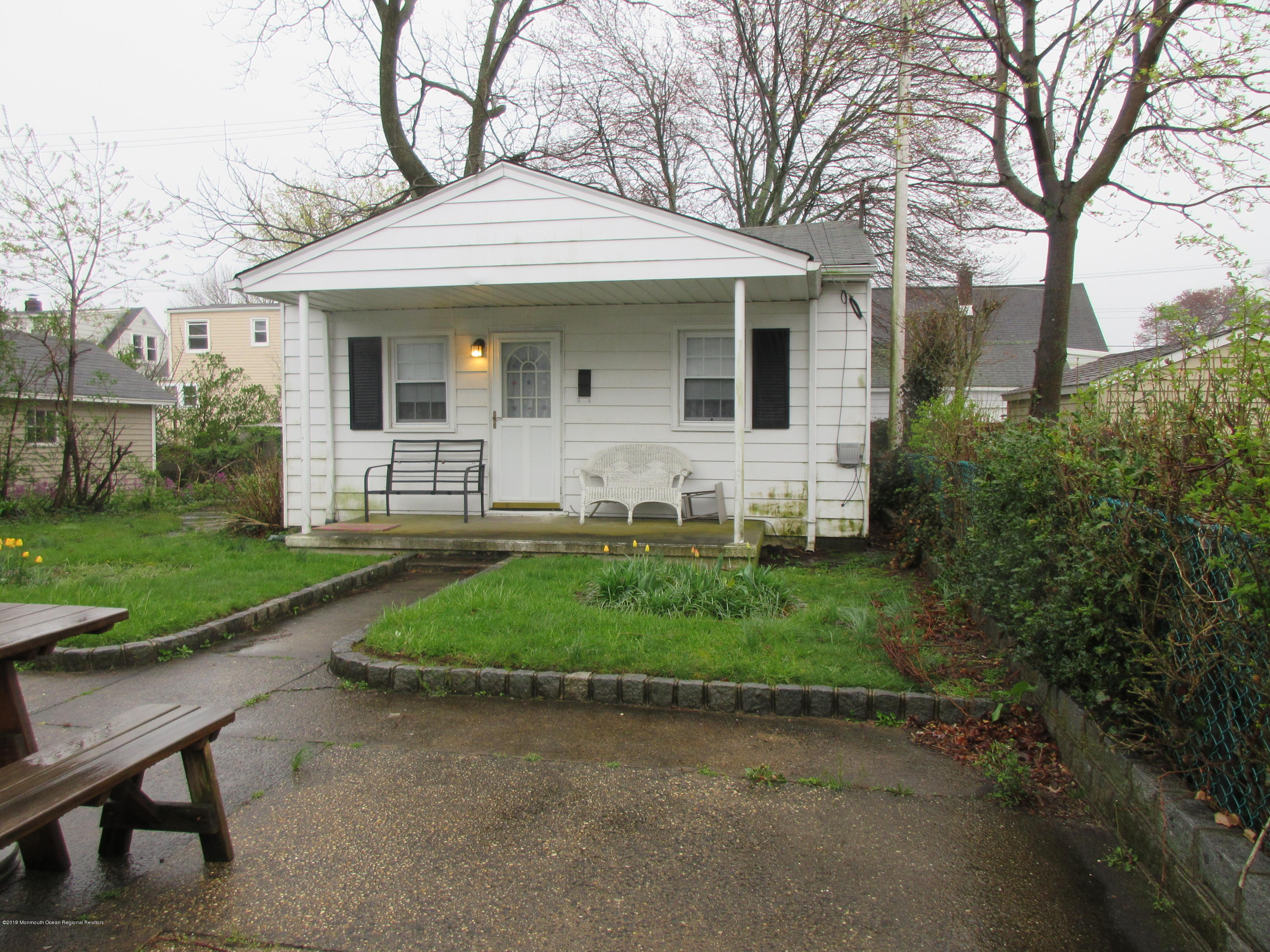 323 15th Avenue, Unit 2 Belmar, NJ 07719 - Photo 1 of 11 a front view of a house with a yard and potted plants