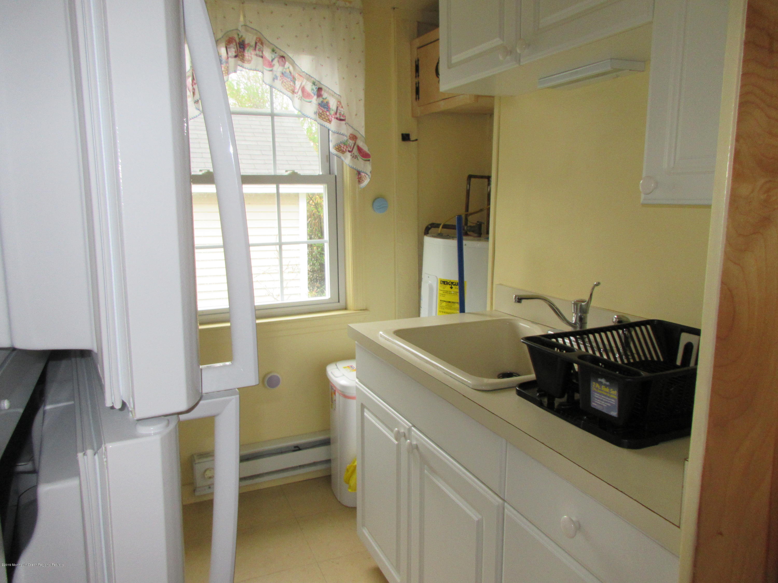 323 15th Avenue, Unit 2 Belmar, NJ 07719 - Photo 7 of 11 a bathroom with a sink and a toilet