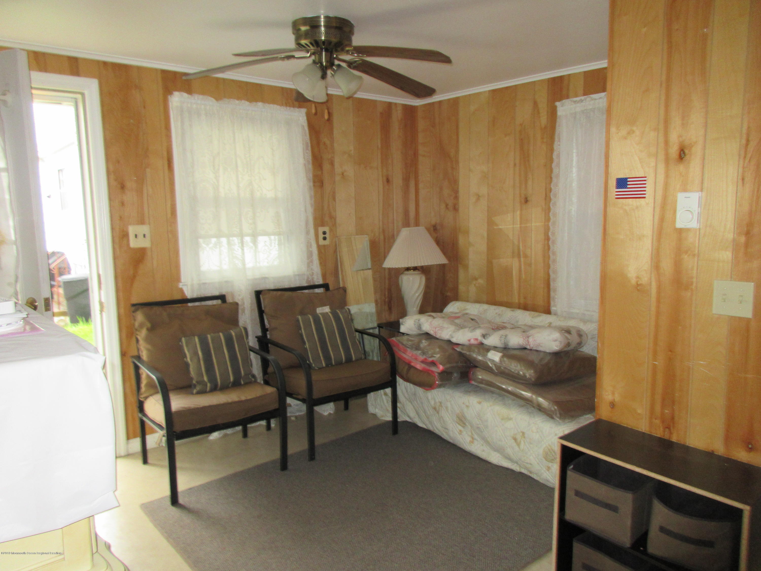 323 15th Avenue, Unit 2 Belmar, NJ 07719 - Photo 9 of 11 a bedroom with a bed and a chandelier