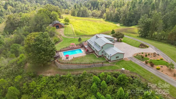 a view of a swimming pool with a yard