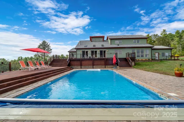 swimming pool view with a seating space and a garden