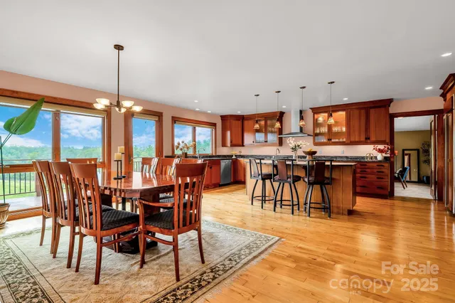 a dining room with furniture a kitchen view and a chandelier