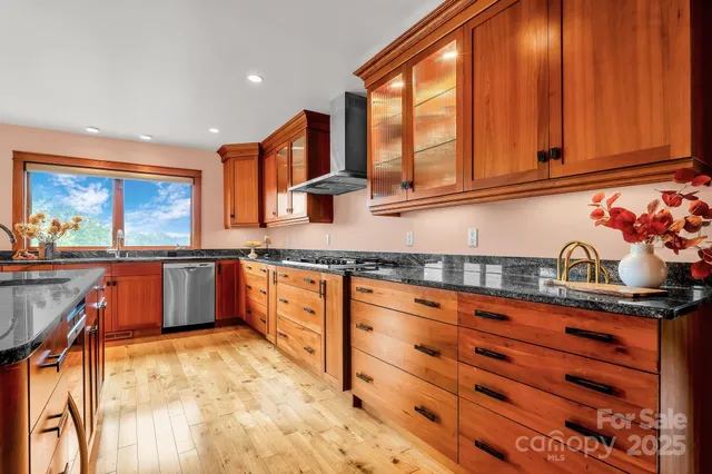 a kitchen with stainless steel appliances granite countertop a sink and cabinets