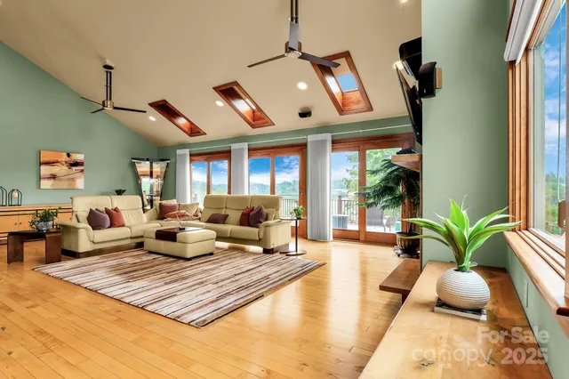 a living room with furniture rug and a large window