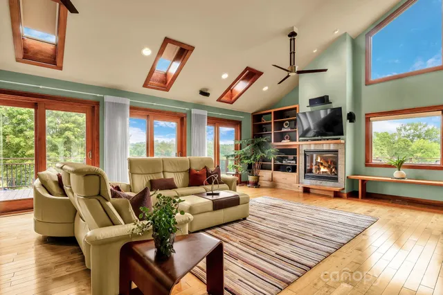 a living room with furniture fireplace and a large window