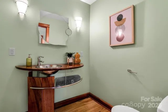 a spacious bedroom with a large bed and a wooden floor