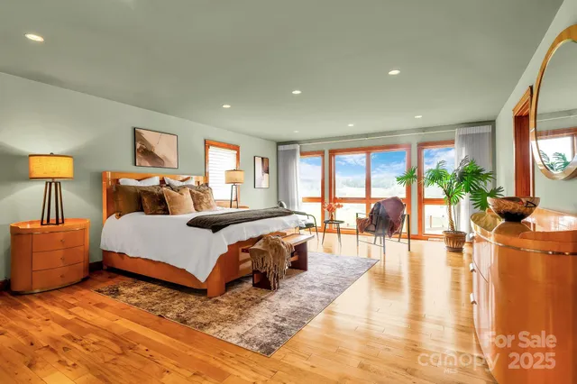 a living room with furniture and floor to ceiling windows