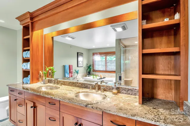 a view of walk in closet with wooden floor