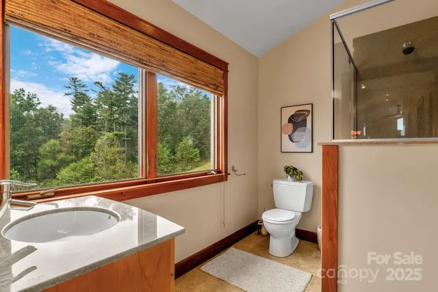 a view of a big room with wooden floor and windows