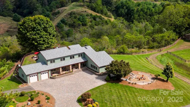 an aerial view of a house with yard swimming pool and outdoor seating
