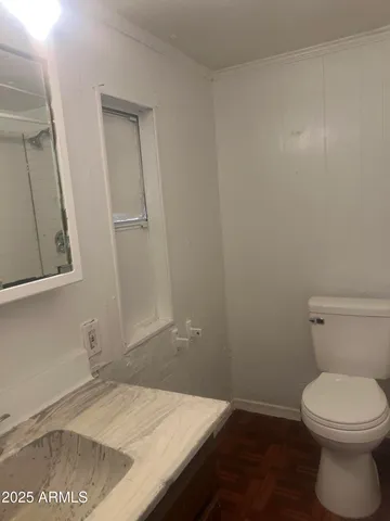 a bathroom with a toilet and shower